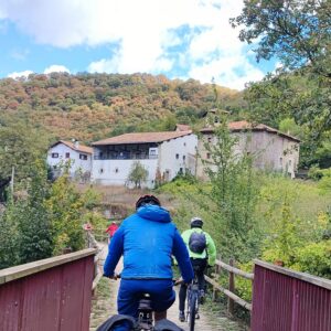 Cyclist going over bridge cycling the greenway in Spain's Basque region