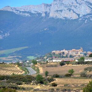 towering mountains above vineyard village La Rioja wine country Green Spain